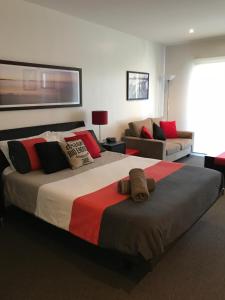 a bedroom with a large bed and a couch at Waterfront@Waves in Cowes