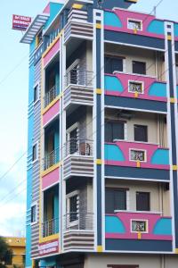 a tall apartment building with colorful balconies at Sri Vally Residency in Pondicherry