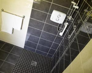 a bathroom with a blue tiled floor and a towel rack at The Waterside Cottages in Nenagh +38 photos