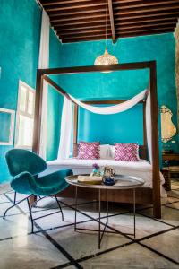 a bedroom with a bed and a table and chairs at Dar Camelia in Soûr