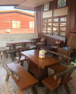 a room with tables and chairs and a couch at ซอยห้า โฮมสเตย์ เชียงคาน in Chiang Khan