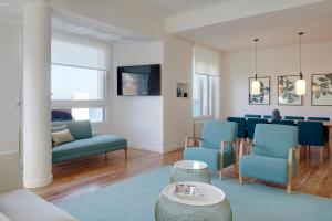 a living room with blue chairs and a table at Mayflower by FeelFree Rentals in San Sebastián