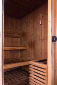 an empty sauna with wooden walls and wooden shelves at Villa Carmel Boutique Hotel in Haifa