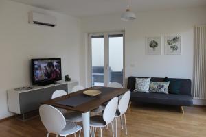 ein Wohnzimmer mit einem Tisch, Stühlen und einem Sofa in der Unterkunft Appartamento Santa Lucrezia in Polignano a Mare