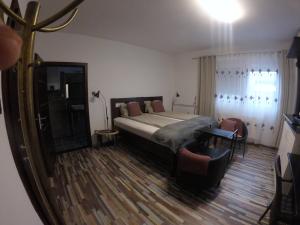 a bedroom with a bed and a mirror at Dózsaház in Zalaegerszeg