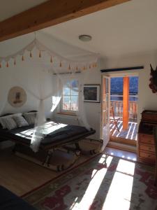 a bedroom with a bed in a room with a porch at KU:L Apartment 4pers. Planai Dachstein in Öblarn