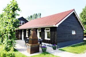 Terwoldeにあるパーク ニューグラーペンダールの錆び屋根の小さな黒い家