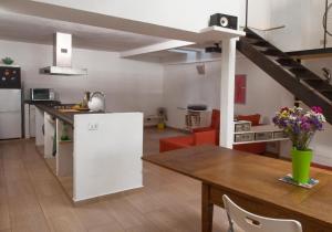 a kitchen and dining room with a white refrigerator and a table at Loft in Authentic Rome Hood in Rome