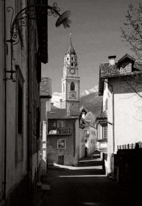a black and white photo of a building with a clock tower at Space Nr. 11 in Merano