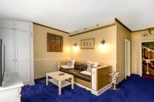 a living room with a couch and a table at Hotel Boyana - Free Parking in Sofia +33 photos