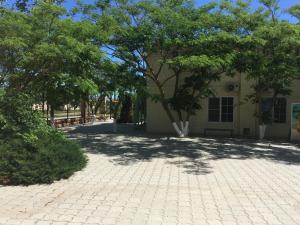 a building with a tree in the middle of a courtyard at Guest House Golubaya Buhta in Kuchugury