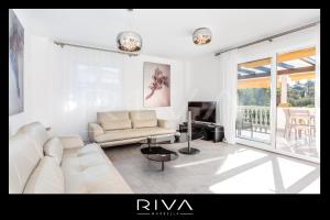Biały salon z kanapą i telewizorem w obiekcie by Riva - 4 bedroom apartment in Dama de noche w Marbelli