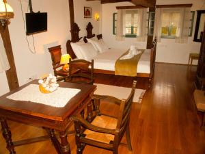a living room with a table and a bed at Stara Iža in Selišće Sunjsko