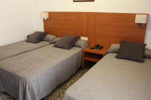 Postel nebo postele na pokoji v ubytování Hotel Jardín