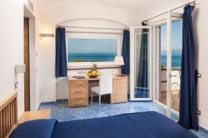 a bedroom with a bed and a window at Grifo Hotel Charme & SPA in Ischia