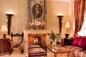 a living room with a couch and a fireplace at Hotel Residence Henri IV in Paris