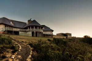 a large house on top of a hill at Hartenbos Private Game Lodge in Hartenbos