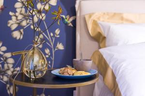 a plate of food on a table next to a bed at Il Gallo in Viterbo