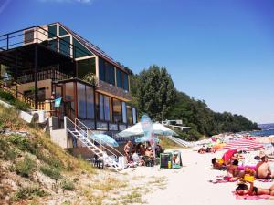 a group of people on a beach near a building at Happy Beach Rooms in Varna City