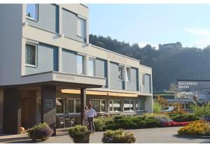 two people standing in front of a building at Sporthotel Kapfenberg in Kapfenberg