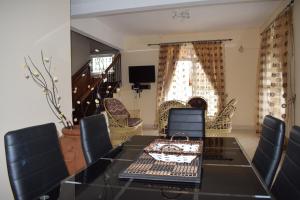 a dining room with a table and chairs at MAIVA KITE VILLA in La Gaulette