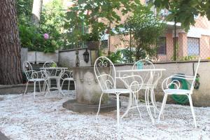 un grupo de sillas y una mesa en un patio en Ianus Guest House, en Roma