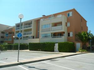 um edifício com uma placa de rua em frente a um parque de estacionamento em Le Ciel Bleu em La Seyne-sur-Mer