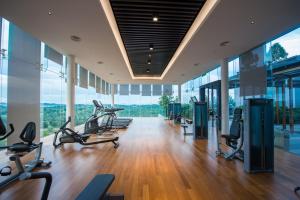 a gym with cardio equipment in a building with large windows at Grand Medini by JBcity Home in Nusajaya