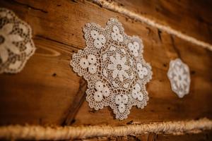 a white lace doily on a wooden wall at Eko Chata Sweet Home in Ustroń