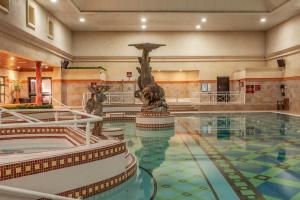 a swimming pool with a statue in a building at Glenroyal Hotel in Maynooth