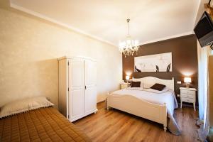 a bedroom with a bed and a chandelier at La Rocchetta in Valeggio sul Mincio