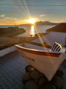 a boat sitting on the ground with the sunset in the background at Casa do Guardião in Madalena