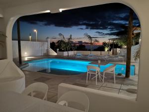 a villa with a swimming pool at night at VILLA8 in Puerto de Santiago
