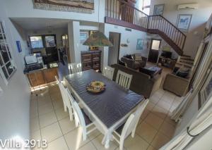 a dining room and living room with a table and chairs at San Lameer Villas Three Bedroom --&-- Two Bedroom in Southbroom