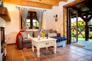 a living room with a couch and a table at Zagroda Krasna in Polańczyk