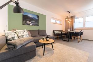 a living room with a couch and a table at Easy Living Apartment Ötztal in Sautens