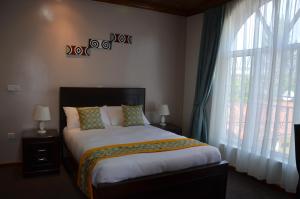 Ein Bett oder Betten in einem Zimmer der Unterkunft Villa Asimba