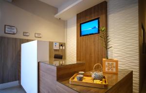 a kitchen with a white refrigerator and a table at Pousada Encantare in Aracaju