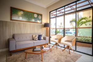 a living room with a couch and a table and chairs at Pousada Encantare in Aracaju