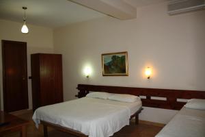 Postel nebo postele na pokoji v ubytování Hotel Martini