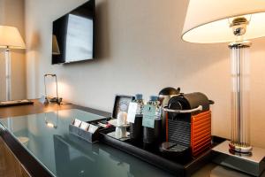 a coffee maker on a desk with a lamp at Kenzi Tower Hotel in Casablanca