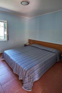 Postel nebo postele na pokoji v ubytování Villaggio L'Oasi