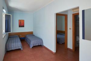 Postel nebo postele na pokoji v ubytování Villaggio L'Oasi