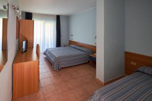 A bed or beds in a room at Villaggio L'Oasi