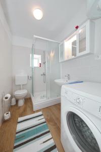 a white bathroom with a washing machine in it at holiday home on DUGI OTOK - OTOK in Brbinj