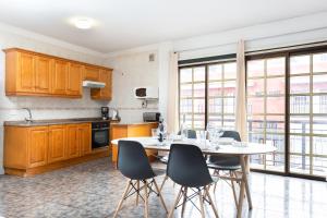 a kitchen with a table and chairs in a room at El Rincón with Teide View III in Icod de los Vinos