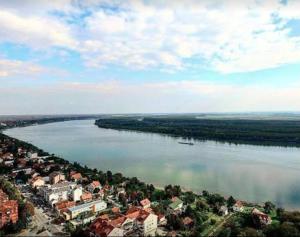 an aerial view of a large river with a city at Dunav97 in Novi Banovci