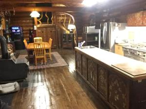 a kitchen with a table and a dining room at Summit River Lodge & Campsites in Valemount