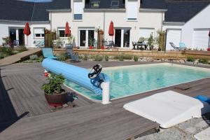 a swimming pool with a blue water slide at les salines de la turballe in La Turballe