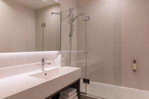 a bathroom with a sink and a glass shower at Best Western Select Hotel in Boulogne-Billancourt +37 photos
